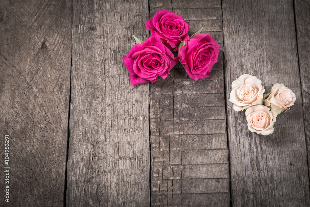 Some cream and pink roses on wooden background Some cream and pink roses on wooden background