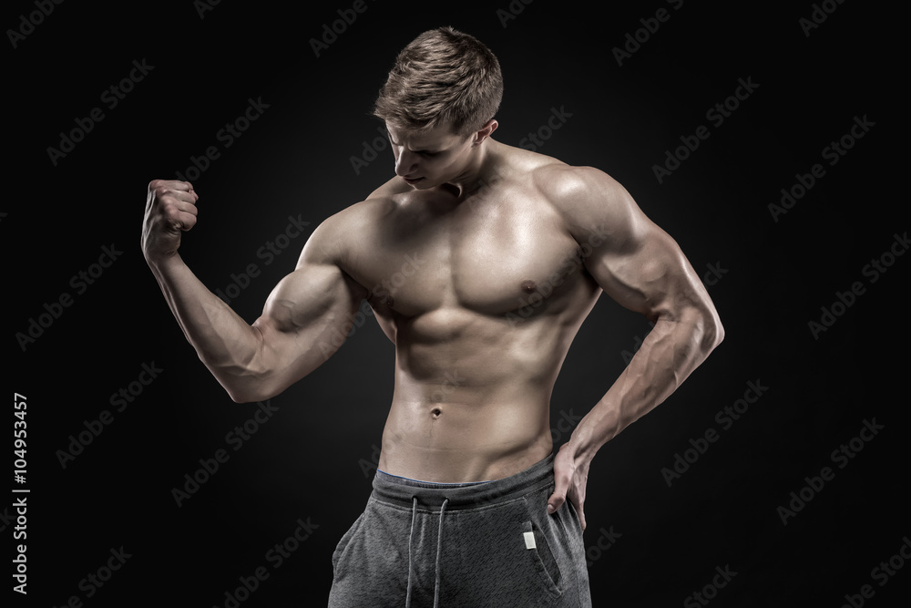 Stunning muscular man showing perfect abs, shoulders, biceps, triceps, chest 