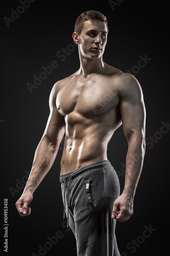 Image of very muscular man posing with naked torso