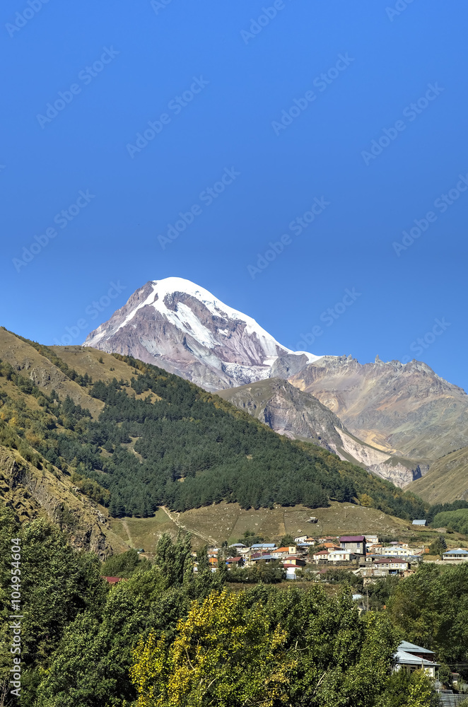 View of Mount Kazbek and Holy Trinity Church (Tsminda Sameba) near Gergeti village, Georgia
