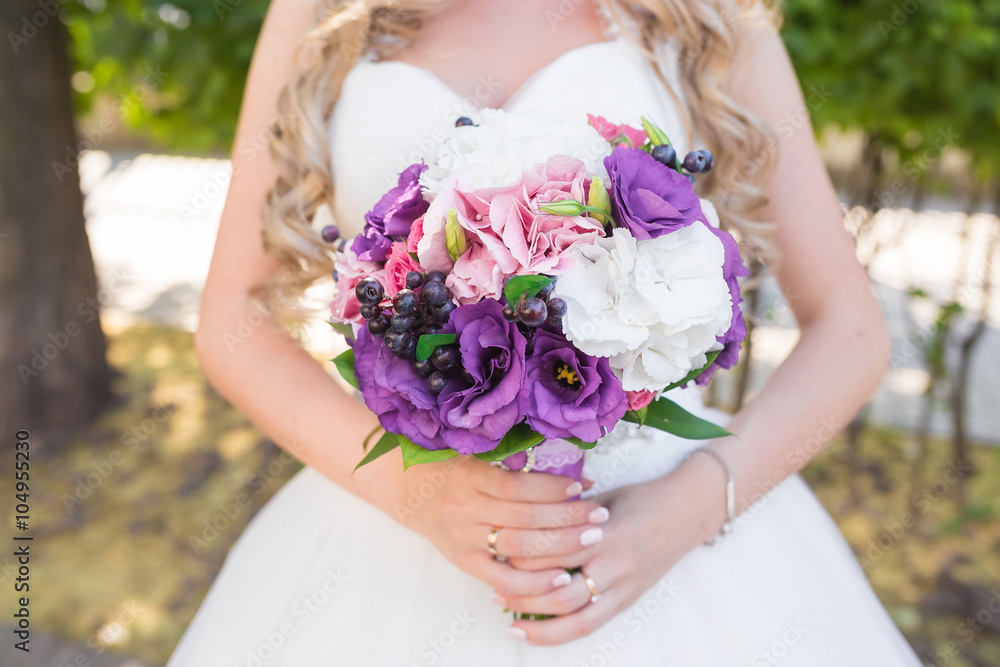 Beautiful wedding bouquet in hands of the bride Beautiful wedding bouquet in hands of the bride