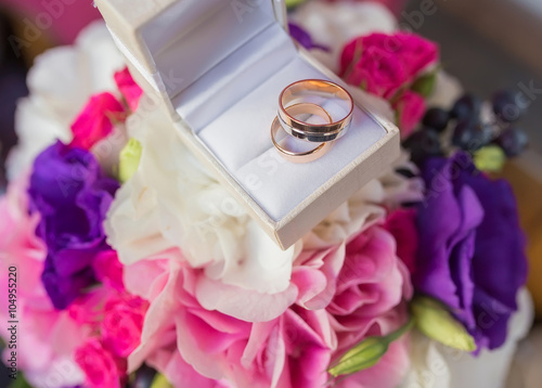 Two wedding rings in a jewelry box on white