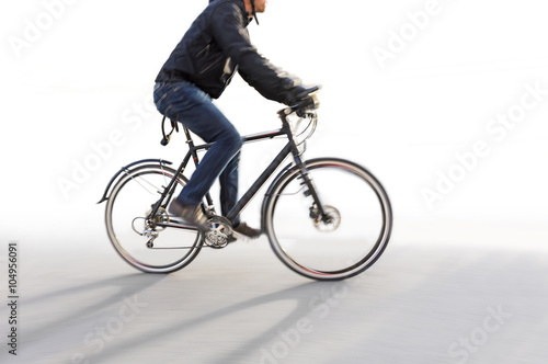 Man riding bike in blurred motion on white