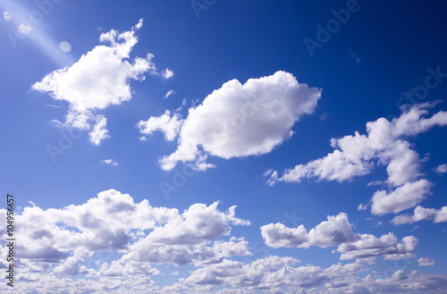 Fluffy white clouds and clear blue sky 