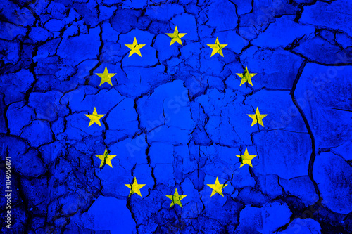 European union flag painted on dry cracked soil texture background. Conceptual disintegration european union background.