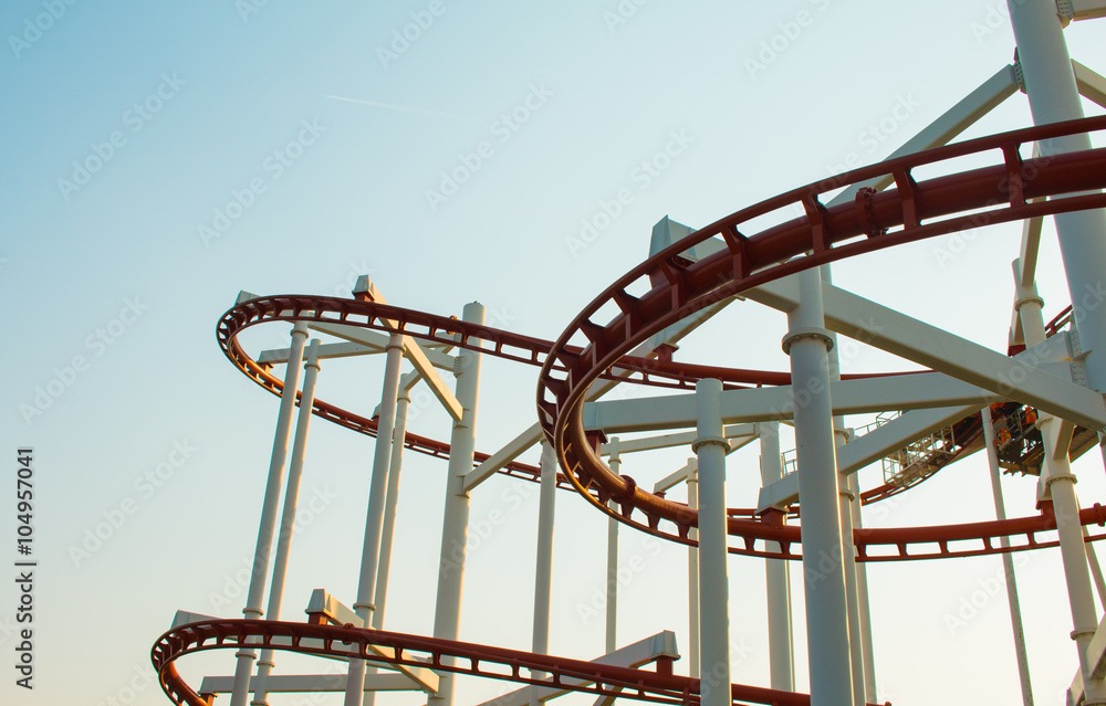 Theme Park Rollercoaster against blue sky . Theme Park Rollercoaster against blue sky .