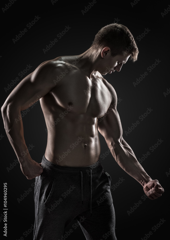 Strong man showing perfect abs, houlders, biceps, triceps and chest Strong man showing perfect abs, houlders, biceps, triceps and chest