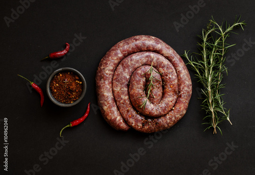 raw beef sausages on a cast-iron pan,  selective focus