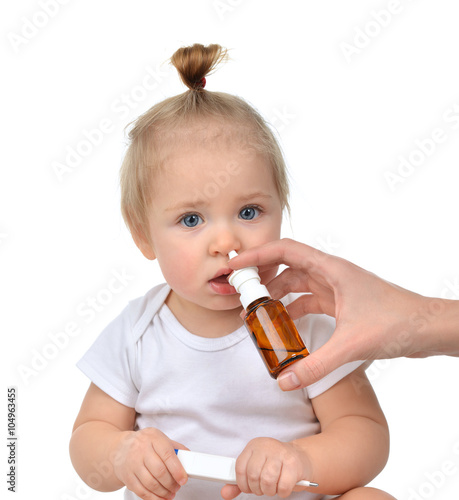 Doctor Woman hand using medicine nose spray nasal for baby toddl photo