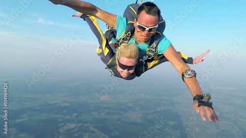 Couple is sky diving in the air