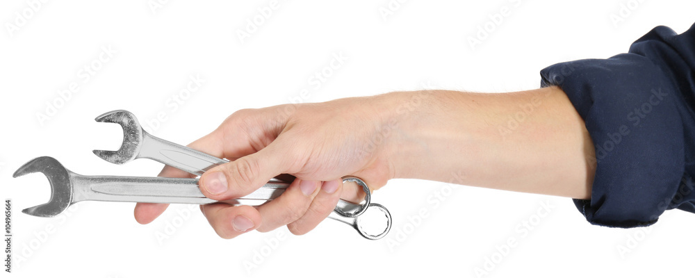 A hand of repairman holding wrenches, on white background, close-up A hand of repairman holding wrenches, on white background, close-up