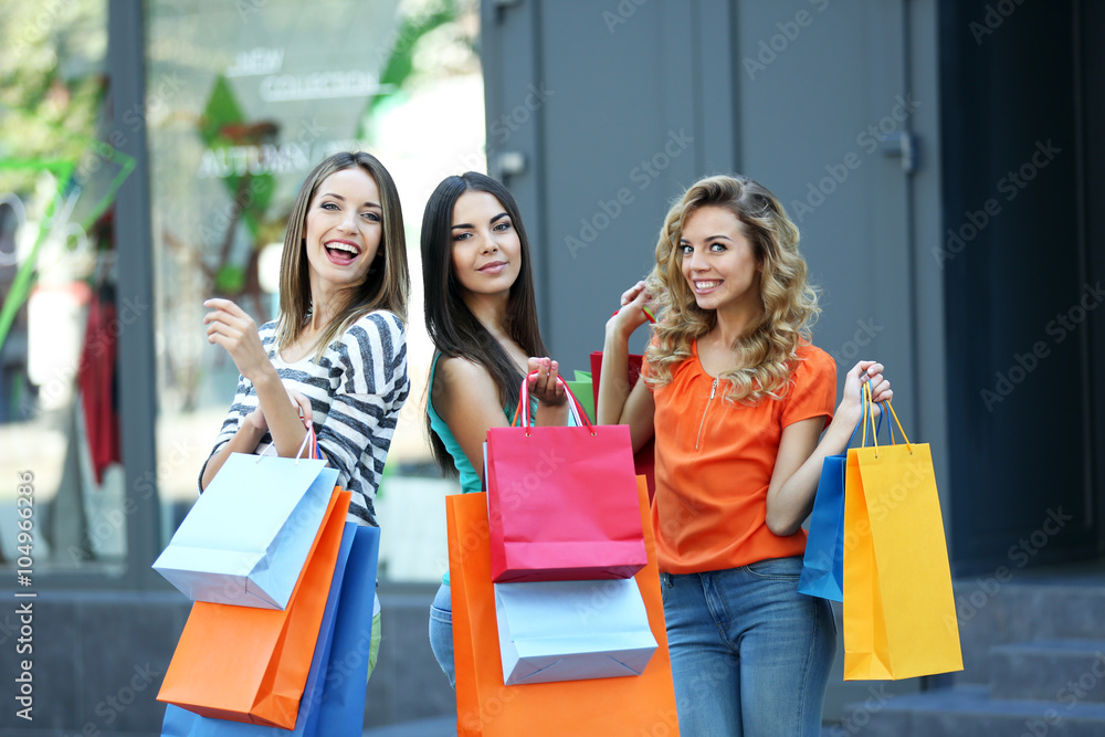Beautiful young women with shopping bags on city street Beautiful young women with shopping bags on city street