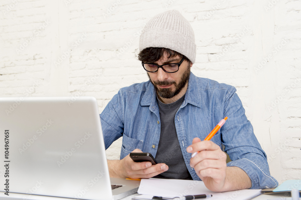  hispanic attractive hipster businessman working at home office using mobile phone