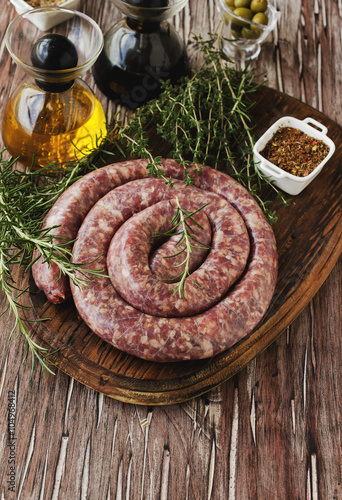 raw beef sausages on a cast-iron pan, selective focus