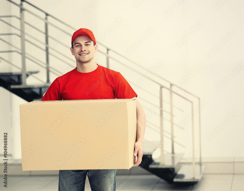 Man holding carton box in the room Man holding carton box in the room