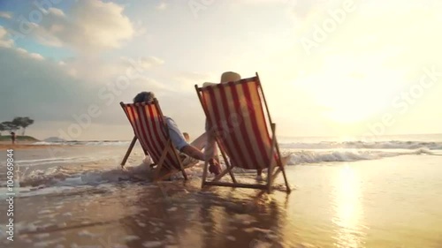 4K Retirement Vacation Concept, Happy Mature Retired Couple Enjoying Beautiful Sunset at the Beach