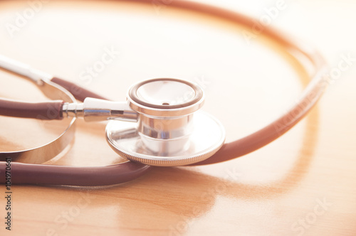 Stethoscope on wooden background for medical or science concept