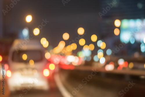 Motion blur of car on the road with abstract light bokeh in the night background
