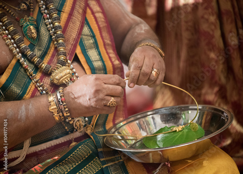 Priest preparing thali at a Ceylonese Hindu wedding