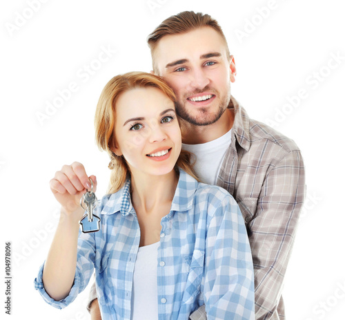 Happy young couple with key...