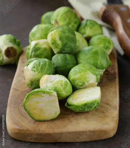 raw fresh organic brussels sprouts on cutting board