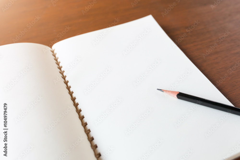 Blank note book with pencil on wooden table background concept a Blank note book with pencil on wooden table background concept a
