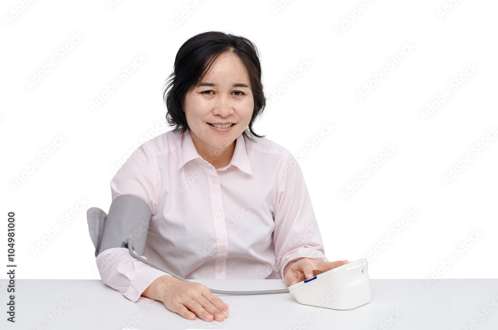Asian woman checking blood pressure by herself Asian woman checking blood pressure by herself