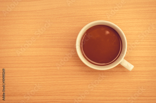 Coffee cup on wood table,top view.