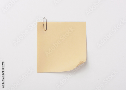 yellow sticky note with paper clip with shade