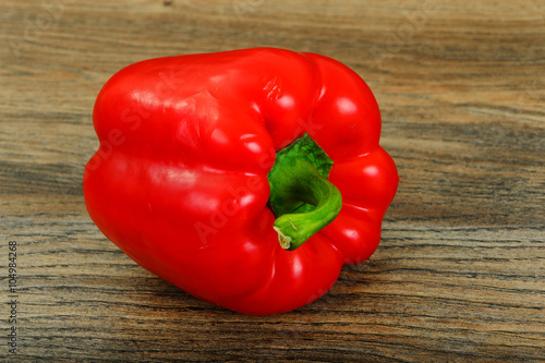 Fresh Red Bell Pepper on Wood Background.