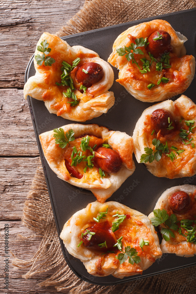 puff buns with sausage in a baking dish closeup. vertical top view
puff buns with sausage in a baking dish closeup. vertical top view