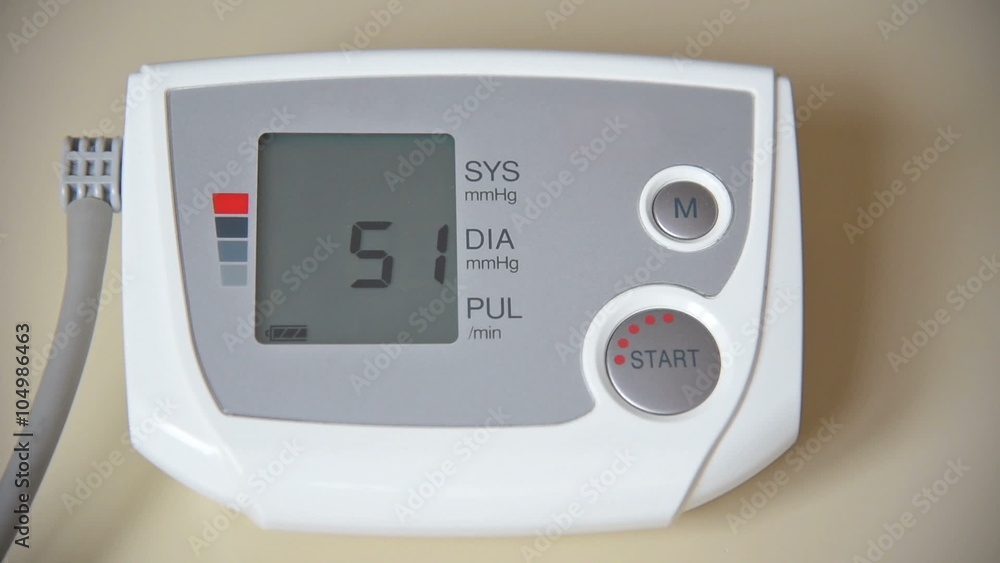 Blood pressure and pulse checking with digital instrument.At the end of the clip instrument is showing high blood pressure measurement (hypertension). Blood pressure and pulse checking with digital instrument.At the end of the clip instrument is showing high blood pressure measurement (hypertension).