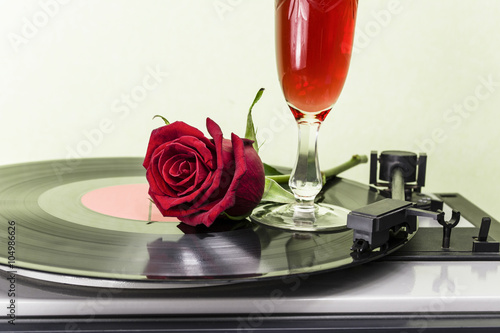Rose and wine on an old record player