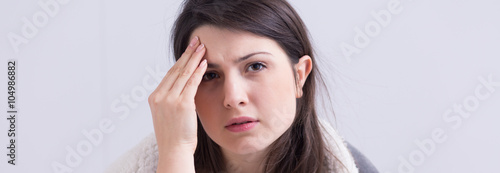 Young woman suffering from headache