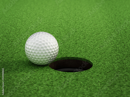Golf ball standing near the hole
