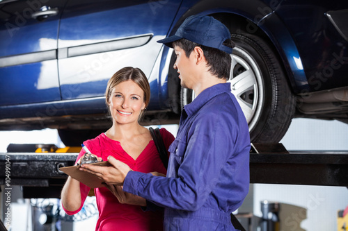 Customer Signing Document While Standing With Technician