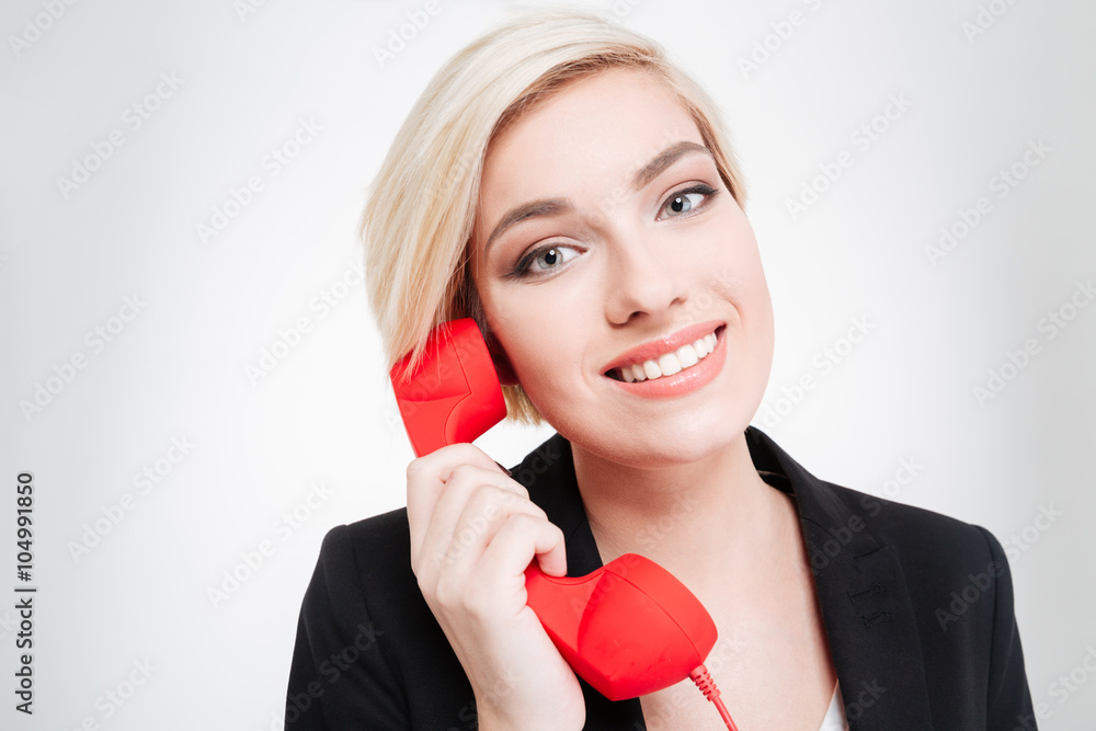Businesswoman talking on the retro phone tube Businesswoman talking on the retro phone tube