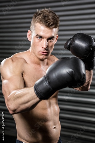 Shirtless man with boxing gloves © WavebreakMediaMicro