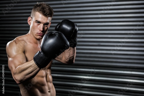 Shirtless man with boxing gloves