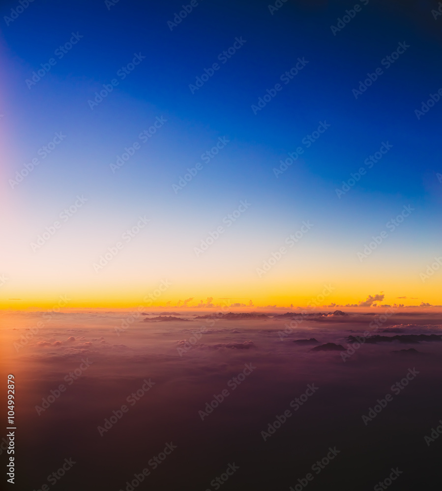 Beautiful colorful sunset over mountains from height of airplane Beautiful colorful sunset over mountains from height of airplane