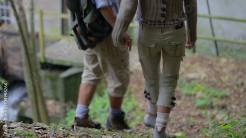 Couple walking down the old stairs in the nature photo