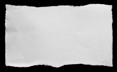 Piece of torn paper on black. Copy space