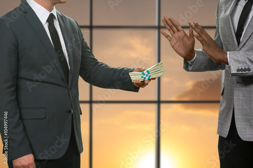 Canvas-taulu Darkskinned businessman refusing huge money.