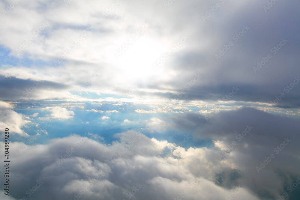 Clouds and sky seen through window of aircraft Clouds and sky seen through window of aircraft