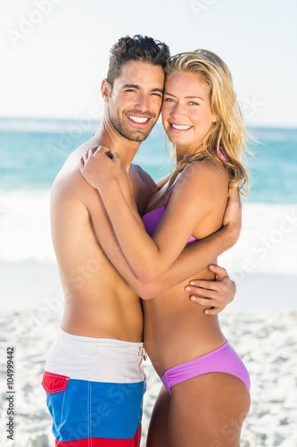 Happy couple hugging on the beach  © WavebreakMediaMicro