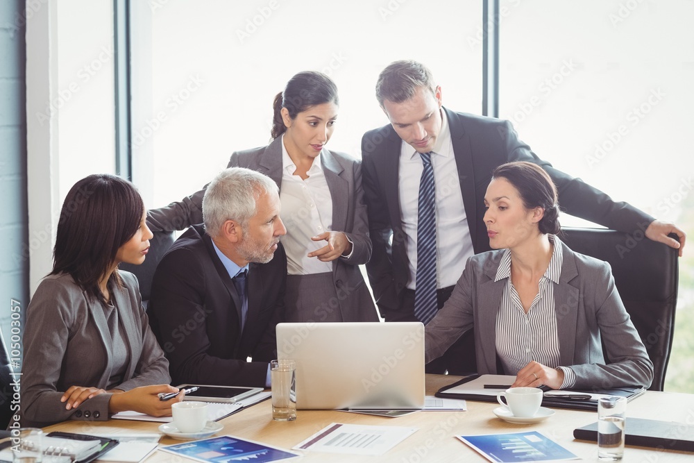 Businesspeople interacting in conference room Businesspeople interacting in conference room