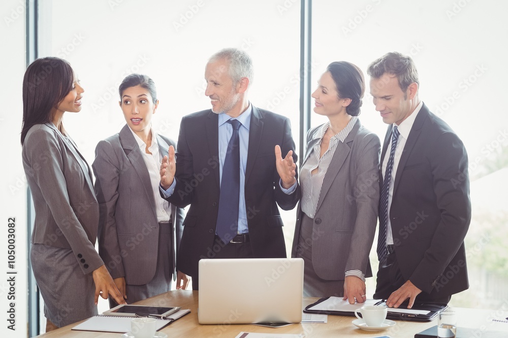 Businesspeople interacting in conference room