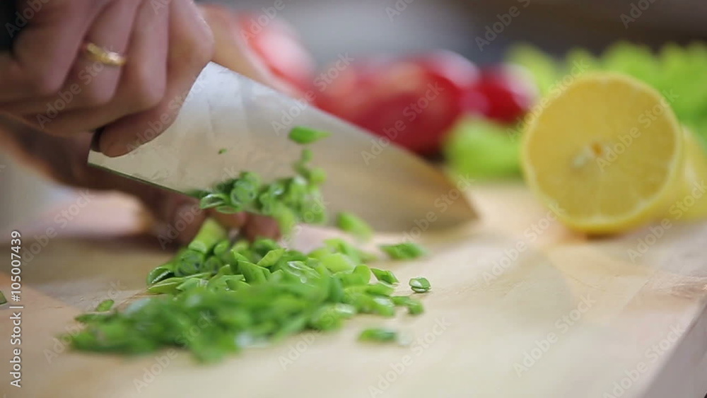 Chef is chopping and slicing fresh green onion Chef is chopping and slicing fresh green onion
