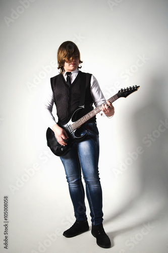 Young happy man with guitar. Isolated on white