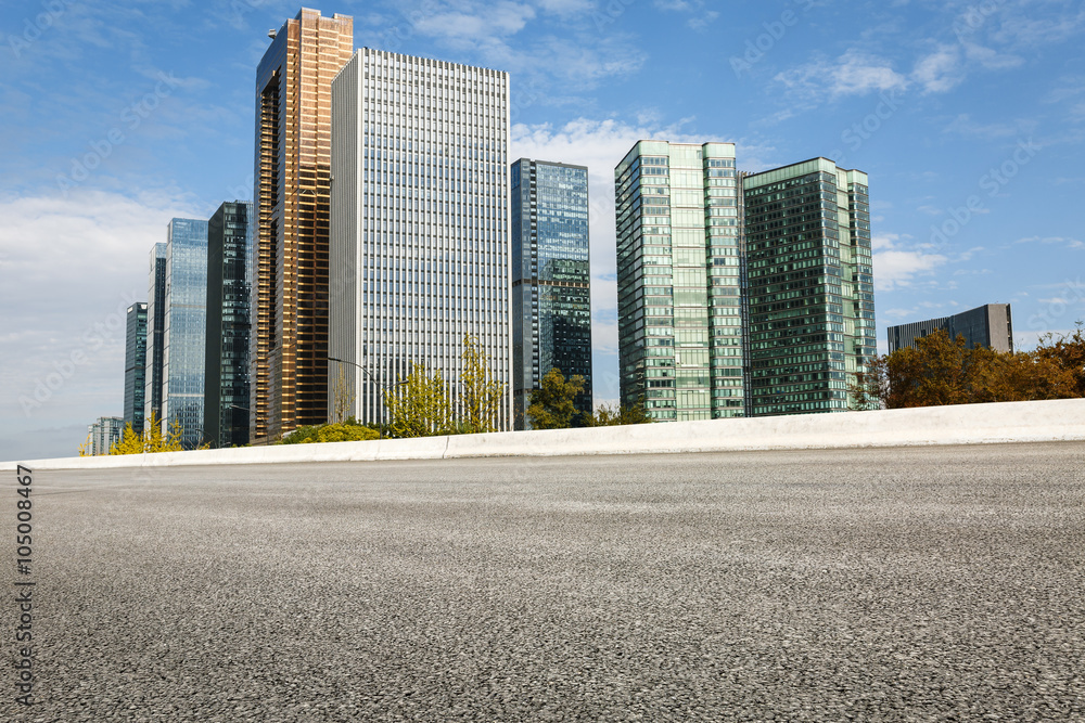 The modern urban commercial building and asphalt road The modern urban commercial building and asphalt road